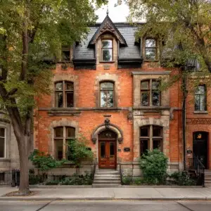 Historic red brick townhouse in Westmount with restored limestone window details and freshly repointed mortar joints